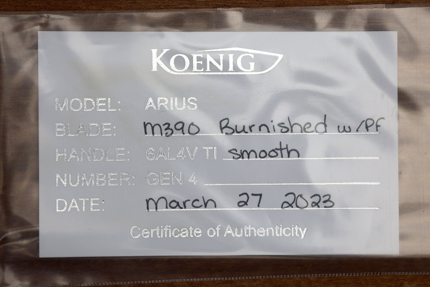 KOENIG KNIVES ARIUS – SMOOTH TITANIUM HANDLE – BLUE HARDWARE – BURNISHED W/ POLISHED FLATS M390 BLADE (PREOWNED)