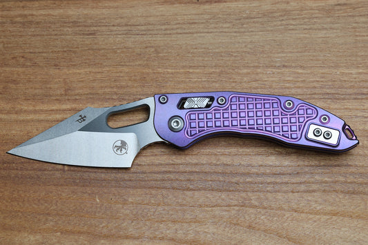 MICROTECH MARFIONE SELECT MANUAL STITCH RAM LOK PURPLE HAZE FRAG TITANIUM HANDLES & STONEWASH M390MK W/ DOUBLE VAPOR BLAST & PURPLE ACCENTS 169RL-10FRMS5