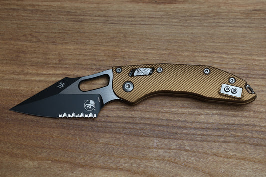 MICROTECH KNIVES MANUAL STITCH RAM LOK FLUTED TAN ALUMINUM & TWO TONE BLACK PARTIAL SERRATED M390MK 169RL-2 FLTA