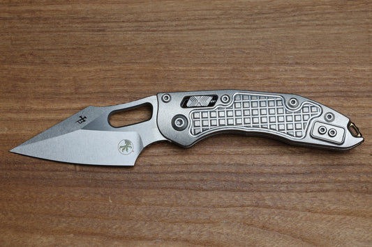 MICROTECH MARFIONE SELECT MANUAL STITCH RAM LOK FRAG TITANIUM HANDLES & STONEWASH M390MK W/ DOUBLE VAPOR BLAST & BRONZE ACCENTS 169RL-10FRMS1