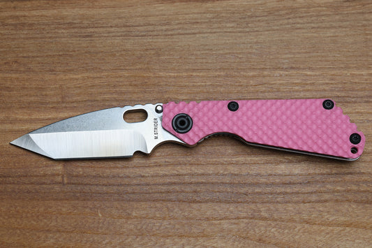 STRIDER KNIVES SNG TWO-TONE SATIN/ STONEWASHED MAGNACUT TANTO BLADE, PINK G10 GUNNER GRIP TOP, STONEWASHED GUNNER GRIP TITANIUM FRAME