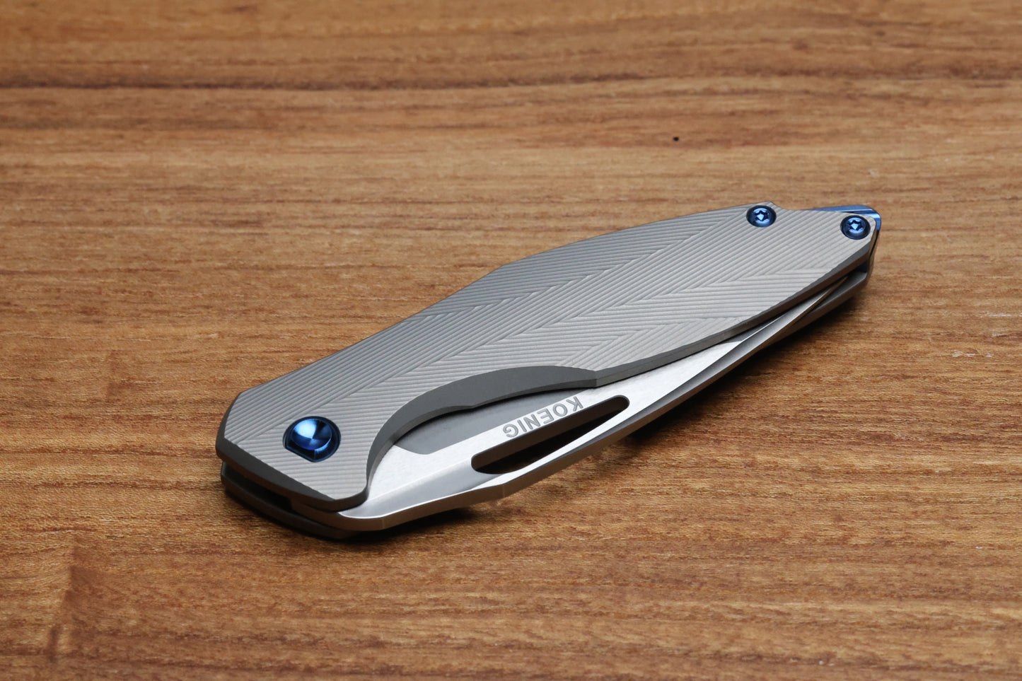 KOENIG KNIVES MINI ARIUS - NON FLIPPER - PATTERNED TITANIUM HANDLE - BLUE HARDWARE - BURNISHED W/ POLISHED FLATS M390 BLADE